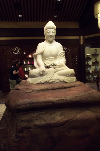 Amazing Buddha statue in the middle of the store. As you can see, people put offerings on it. Amazing Buddha statue in the middle of the store. As you can see, people put offerings on it.