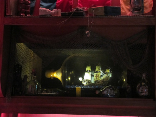 The standard ship in the bottle... or is it?  When a switch is activated by the bartender, the ship scene changes to a monsoon storm with lightning and all.  The ship sways back and forth until it actually sinks into the water.  I don't know how they were able to achieve this effect, but it's totally awesome to see!