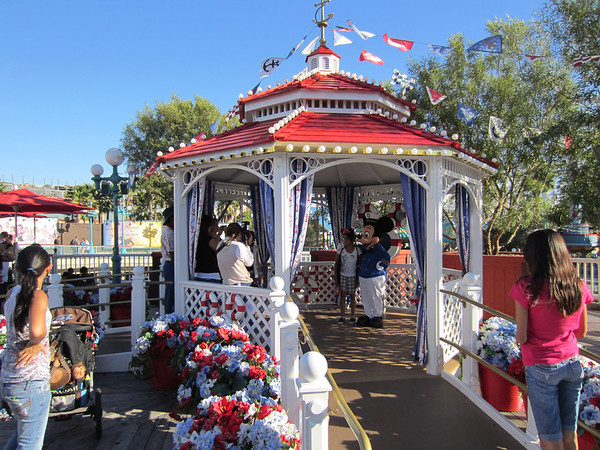 Captain Mickey out taking photos with guests.